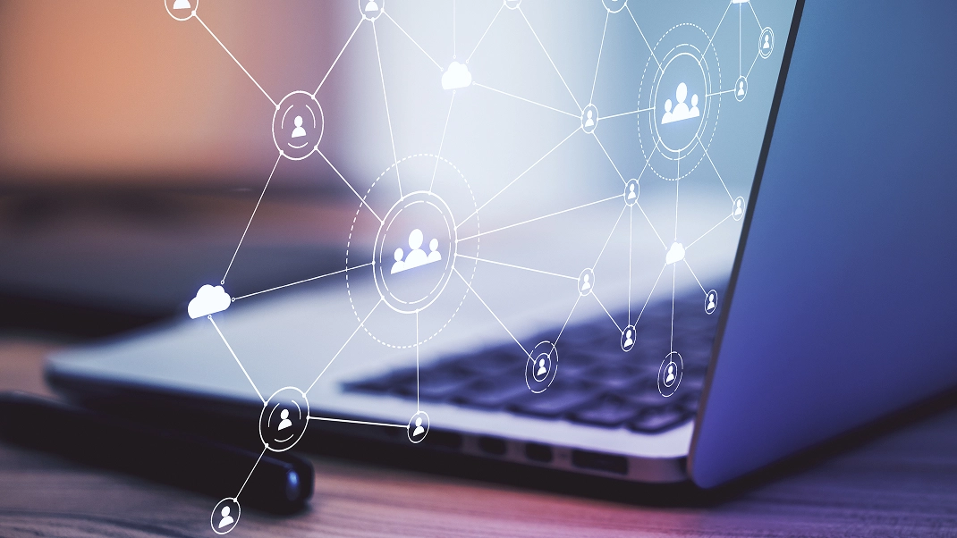 Laptop displaying digital network icons, symbolizing global connectivity and communication technology.