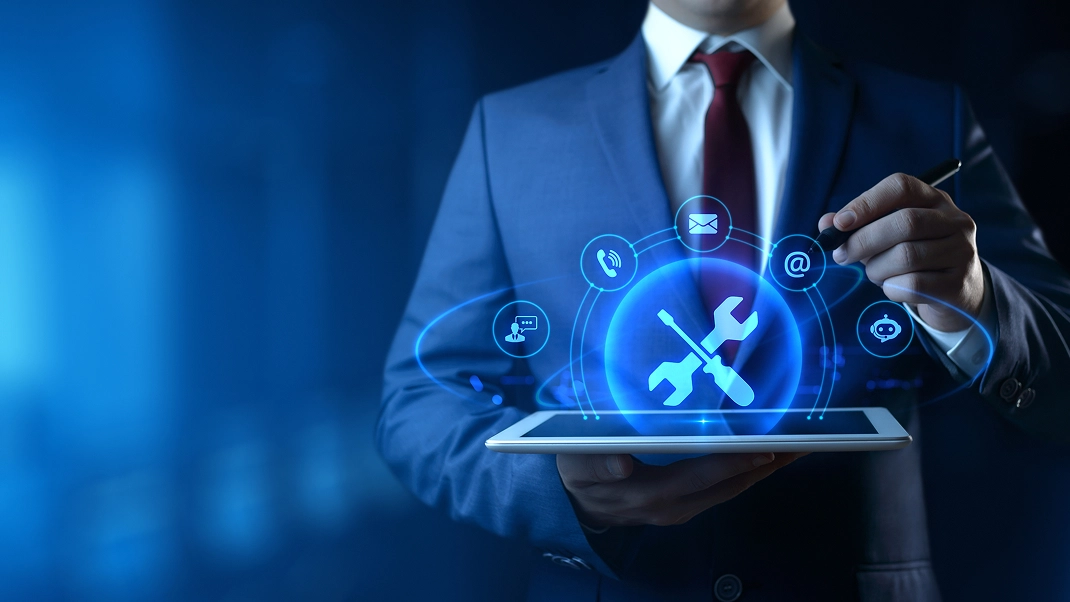Businessman using a tablet with digital tools and communication icons, symbolizing modern technology and business solutions.
