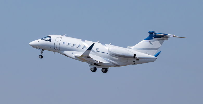 Private jet taking off into a clear blue sky, showcasing modern aviation technology and luxury air travel.